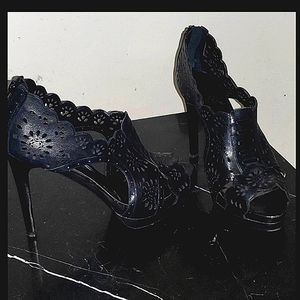 Spiked black leather crochet look heels.